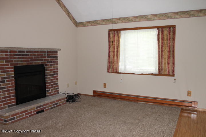 709 Edgewood Road Tobyhanna, PA 18466 - Photo 13 of 55 a room with a fireplace and a window