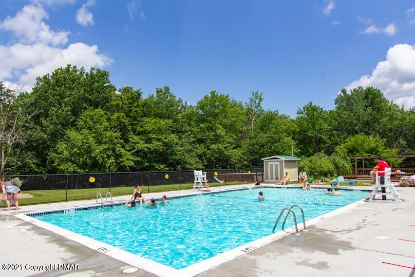 709 Edgewood Road Tobyhanna, PA 18466 - Photo 55 of 55 a view of a swimming pool with a bench and trees around