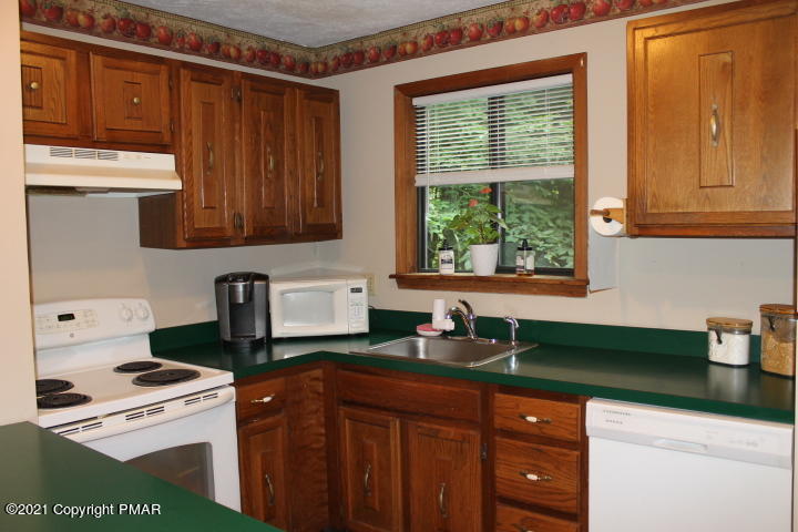 709 Edgewood Road Tobyhanna, PA 18466 - Photo 7 of 55 a kitchen with a cabinets a sink and a stove top oven