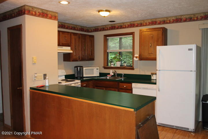 709 Edgewood Road Tobyhanna, PA 18466 - Photo 9 of 55 a kitchen with stainless steel appliances granite countertop a refrigerator a sink dishwasher a stove with white countertops and wooden floor