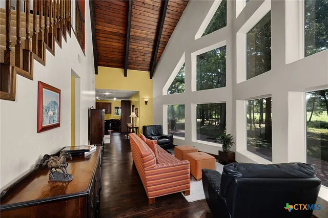 a living room with furniture fireplace and flat screen tv
