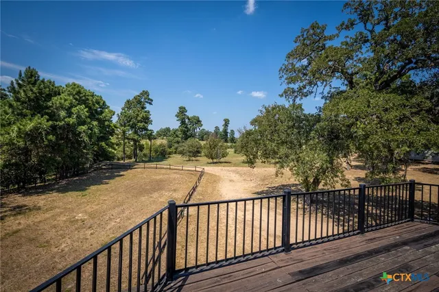 a view of balcony with wooden floor and fence