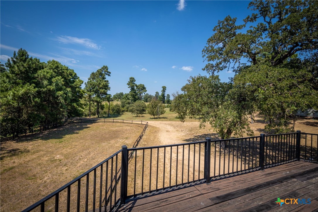 1031 Angel Lake Estates Road Alleyton, TX 78935 - Photo 21 of 47 a view of balcony with wooden floor and fence