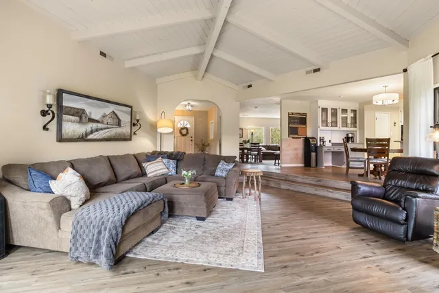 a spacious bathroom with a granite countertop sink and a mirror