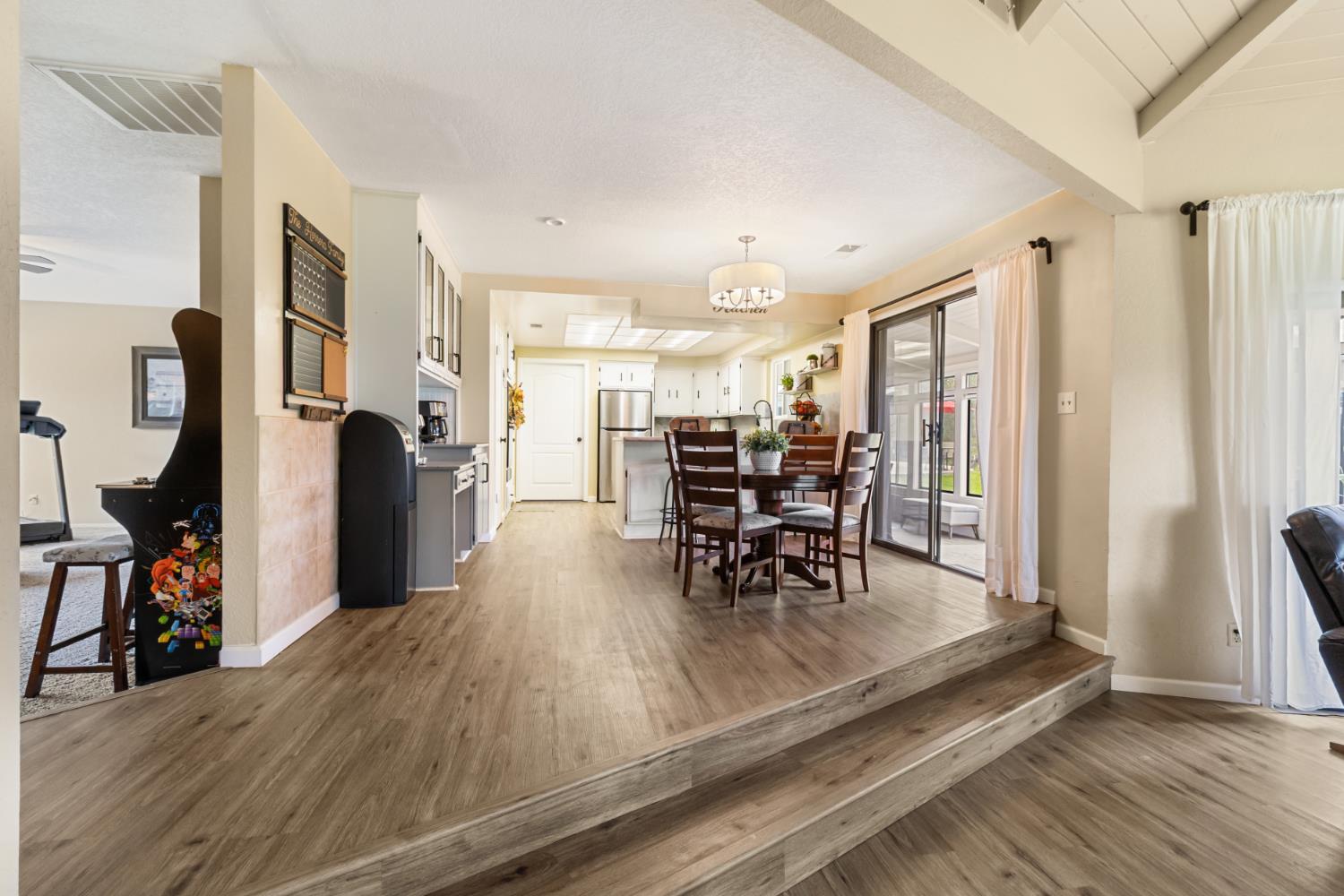 22800 Latrobe Road Plymouth, CA 95669 - Photo 19 of 81 a view of a dining room with furniture and a chandelier