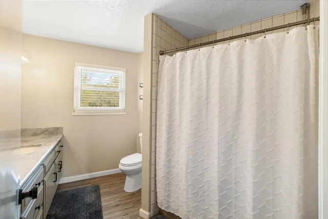 a living room with a bed and a window