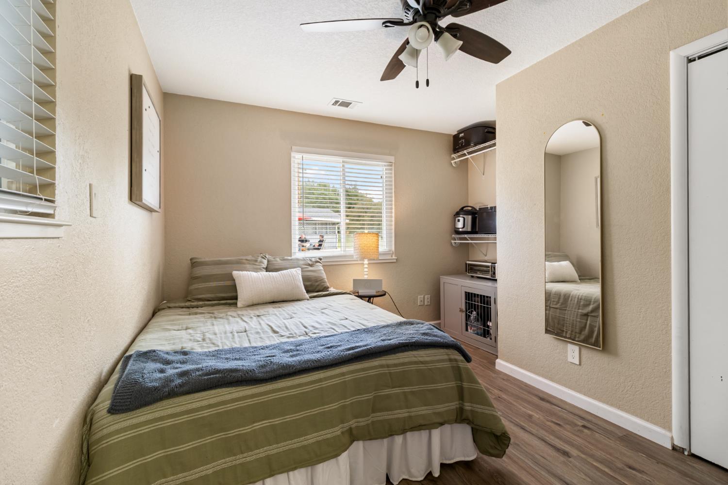 22800 Latrobe Road Plymouth, CA 95669 - Photo 35 of 81 a bedroom with a bed and a chandelier