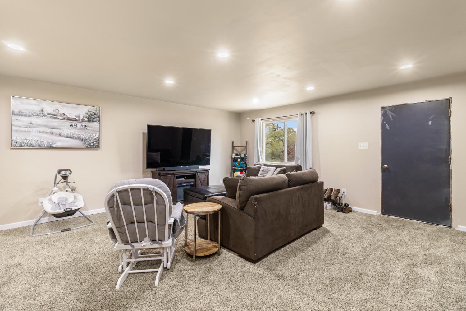 22800 Latrobe Road Plymouth, CA 95669 - Photo 46 of 81 a living room with furniture and a flat screen tv