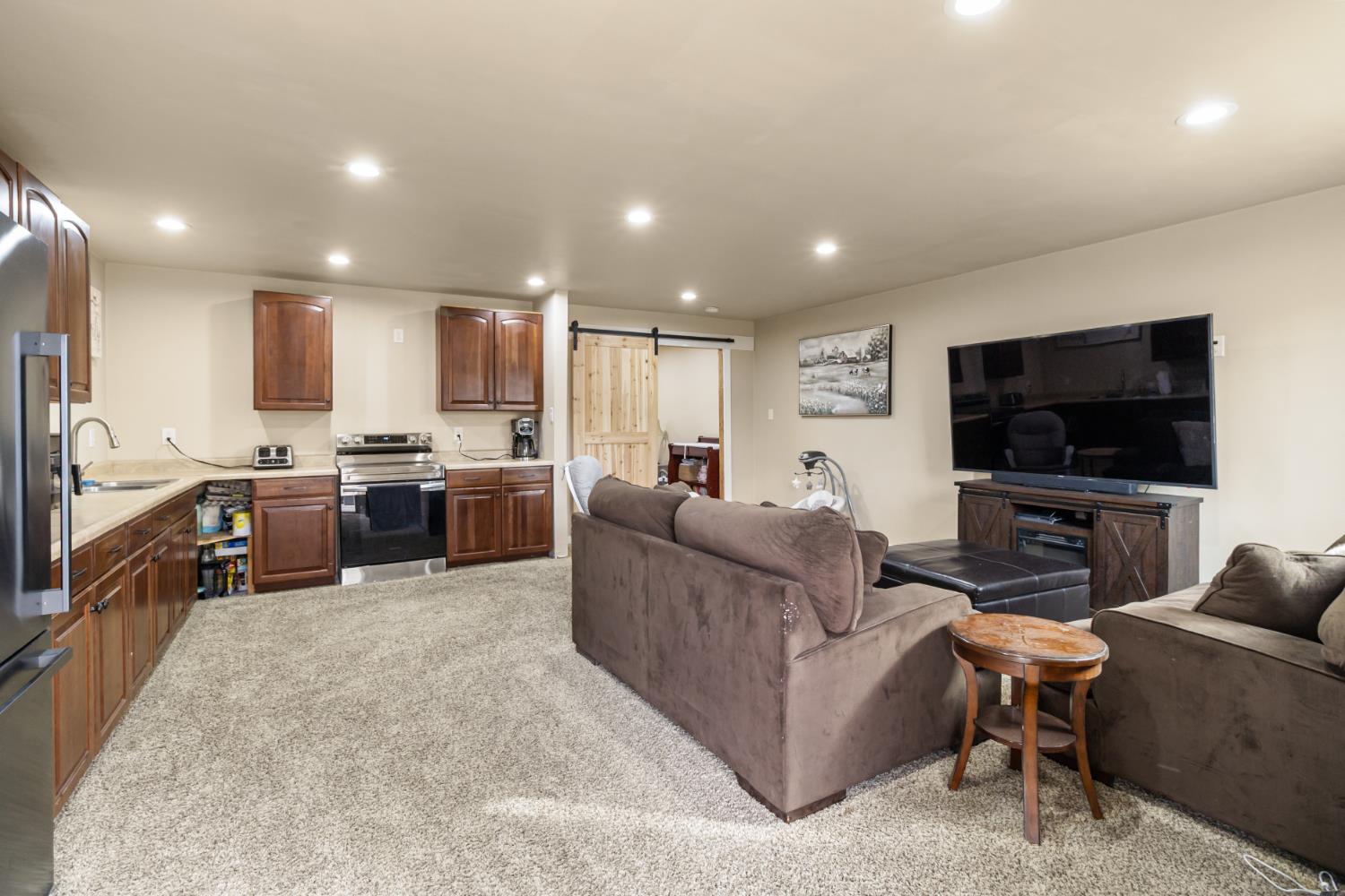 22800 Latrobe Road Plymouth, CA 95669 - Photo 47 of 81 a living room with furniture and a flat screen tv