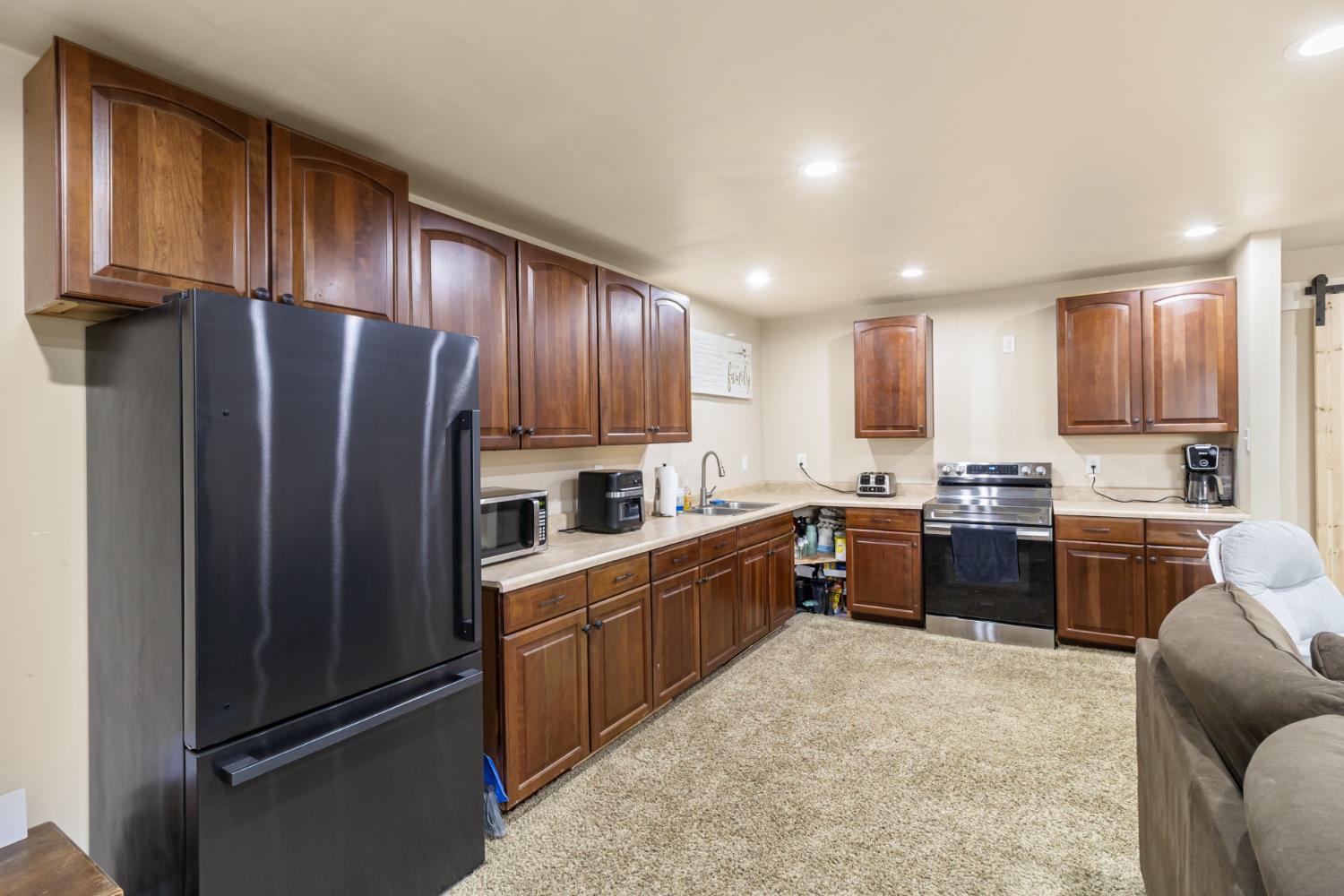 22800 Latrobe Road Plymouth, CA 95669 - Photo 49 of 81 a kitchen with granite countertop stainless steel appliances a refrigerator sink microwave and cabinets