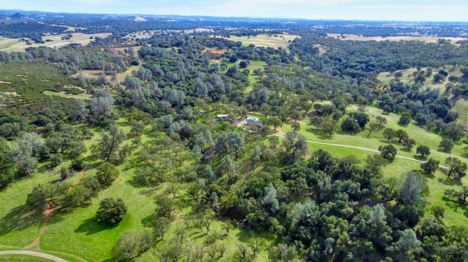 22800 Latrobe Road Plymouth, CA 95669 - Photo 79 of 81 an aerial view of a houses with a lush green hillside