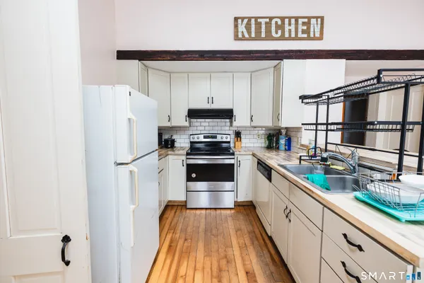 a kitchen with stainless steel appliances a refrigerator and a stove