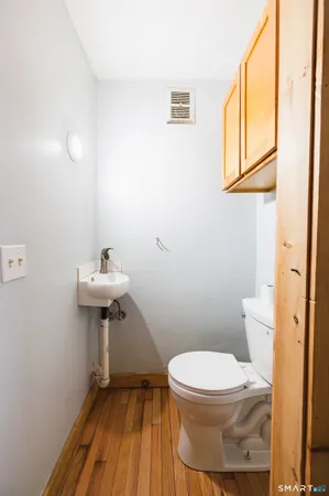 a bathroom with a sink toilet and a mirror