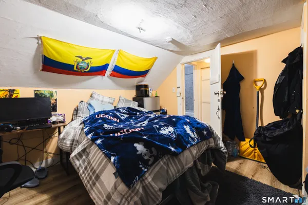 a bed in a bedroom next to a window