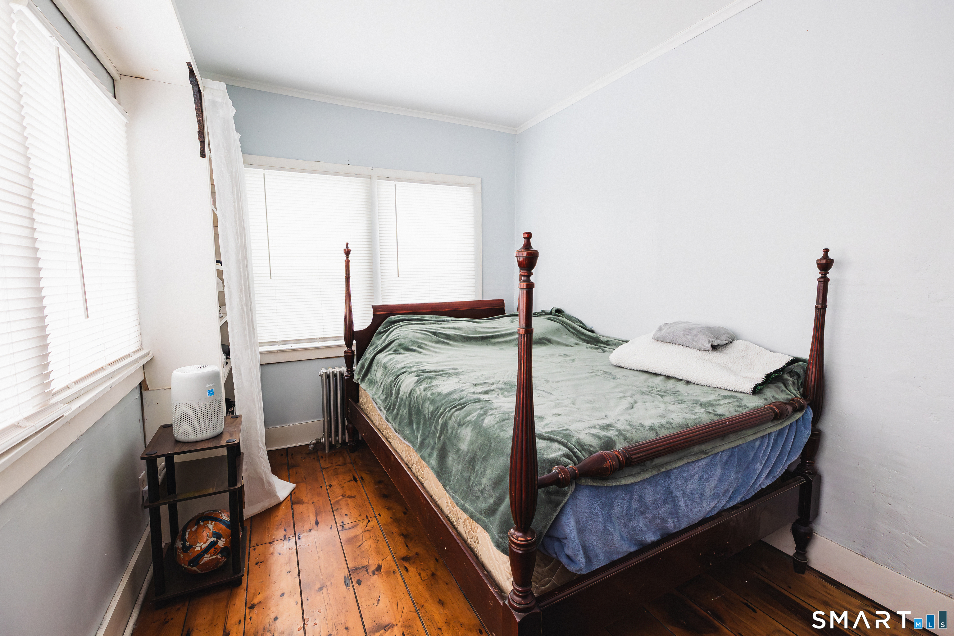 934 Storrs Road Mansfield, CT 06268 - Photo 21 of 24 a bed sitting in a bedroom next to a window