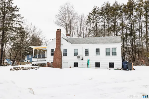 a view of a house with snow on the road