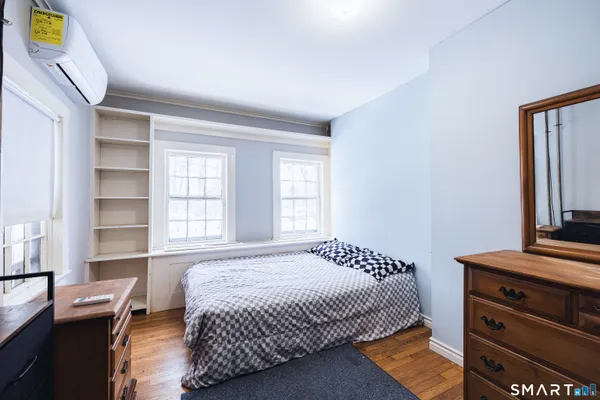 a bedroom with a bed and a window