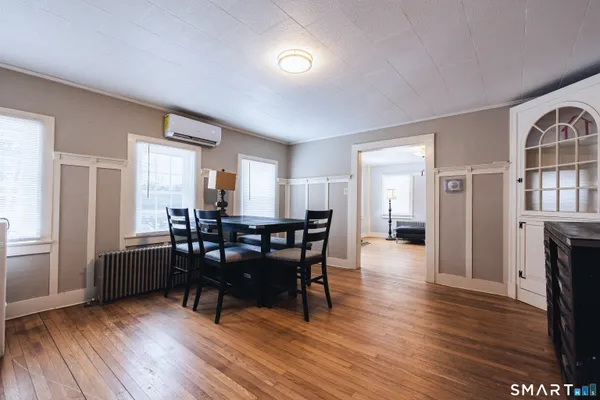 a view of a dining room with furniture and wooden floor