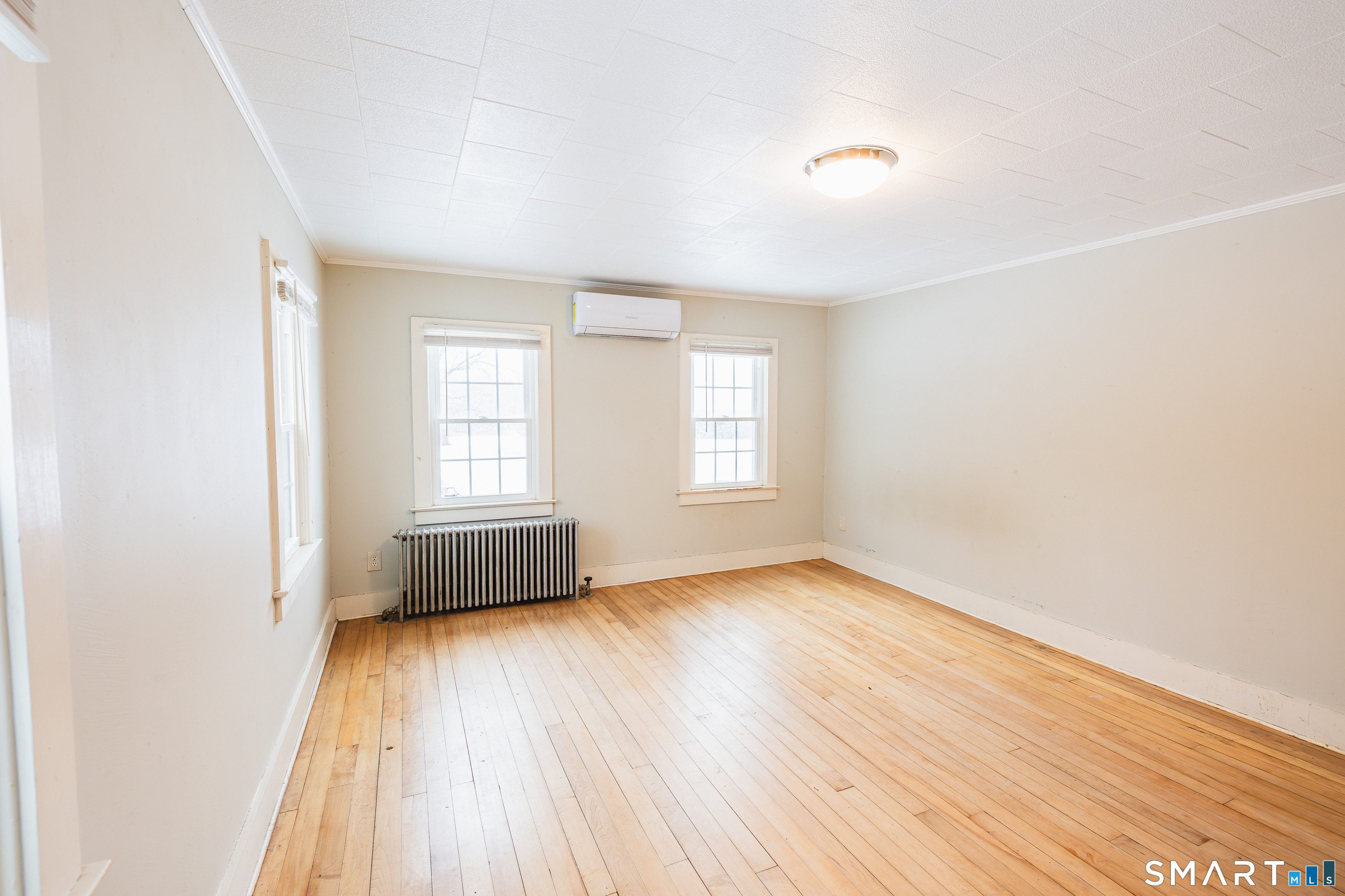 934 Storrs Road Mansfield, CT 06268 - Photo 8 of 24 an empty room with wooden floor and windows