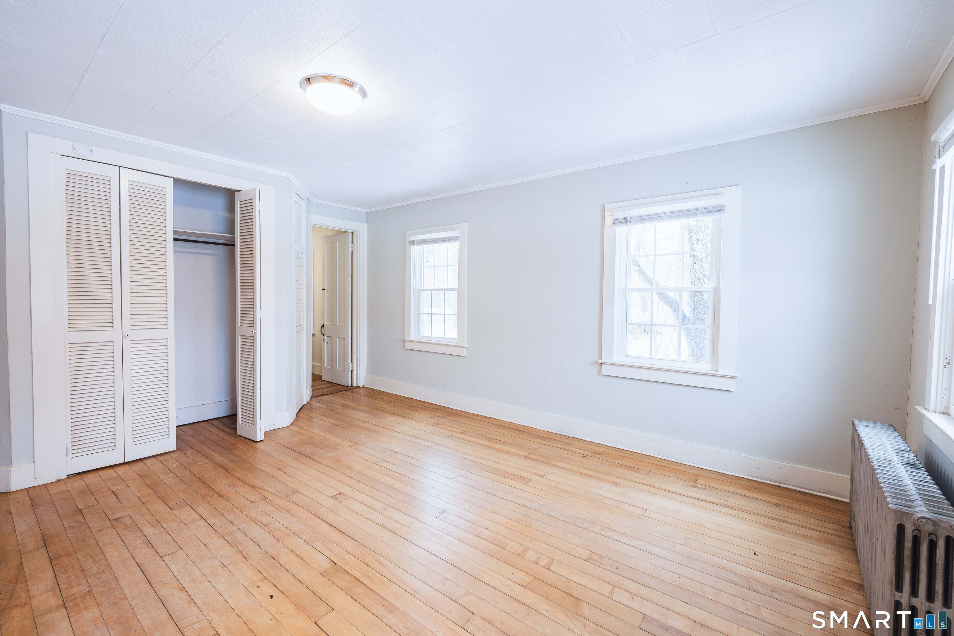 934 Storrs Road Mansfield, CT 06268 - Photo 9 of 24 a view of an empty room with wooden floor and a window