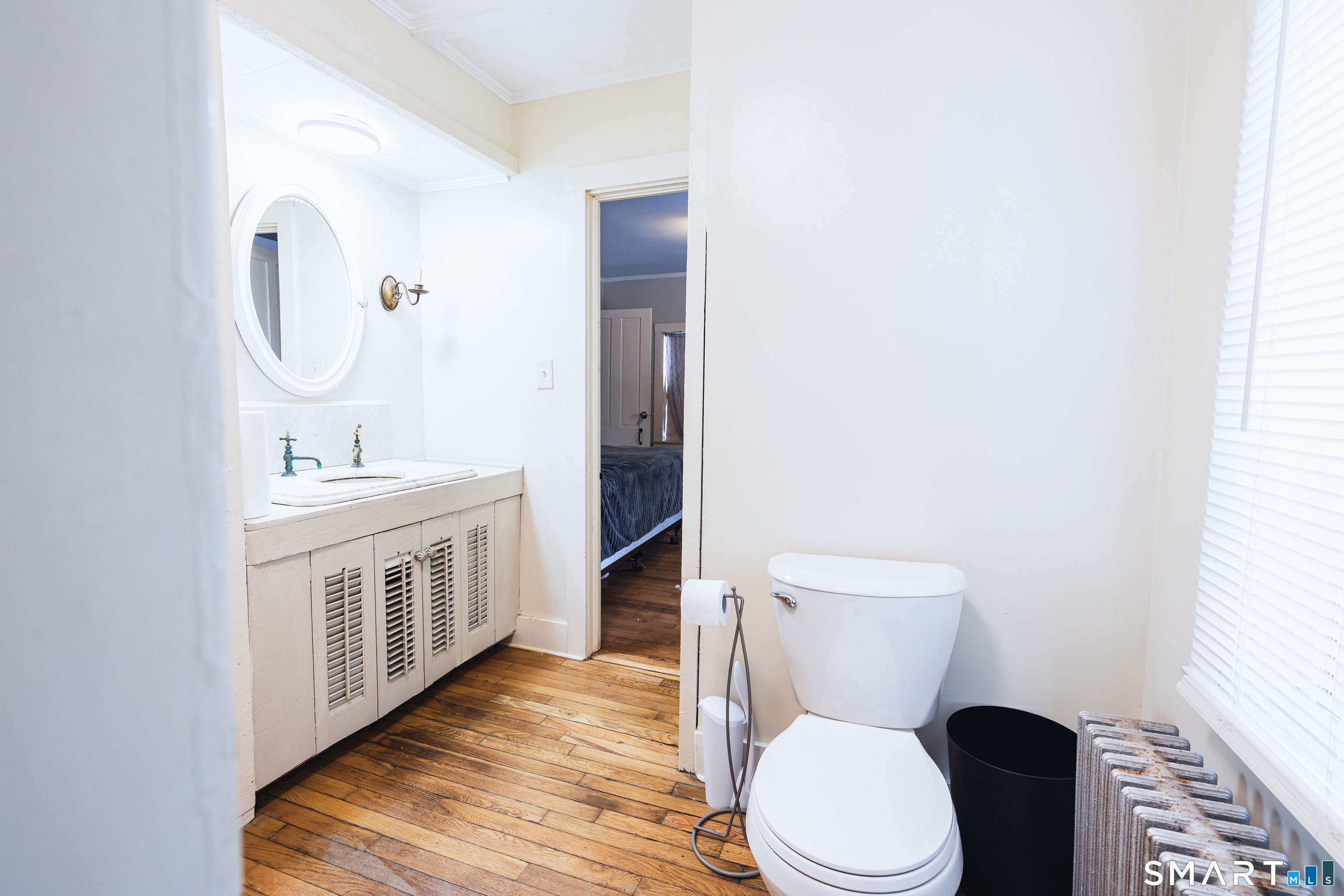 934 Storrs Road Mansfield, CT 06268 - Photo 10 of 24 a bathroom with a toilet a sink a vanity and mirror
