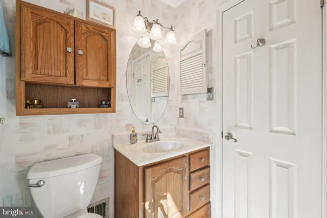 a bathroom with a toilet sink and mirror