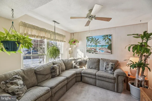 a living room with furniture a chandelier and a window