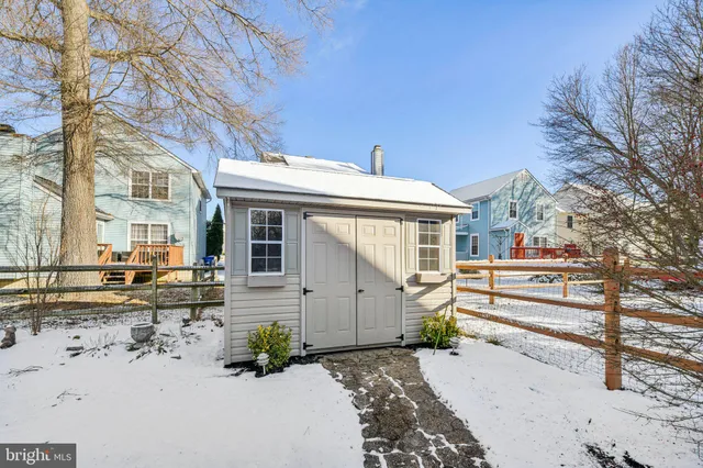 a view of a chair and table in the back yard of the house