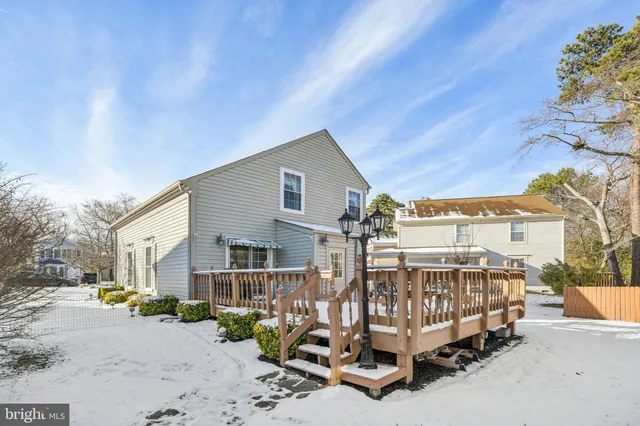 a view of a house with wooden fence