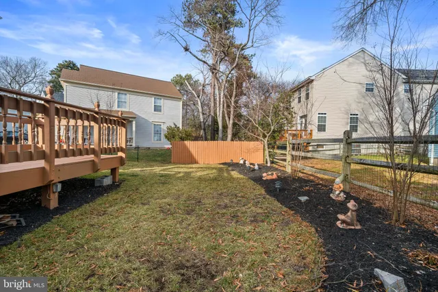 a view of a house with wooden fence