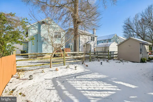 a front view of a building with table and chairs