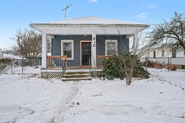 a view of a house with a snow in the yard