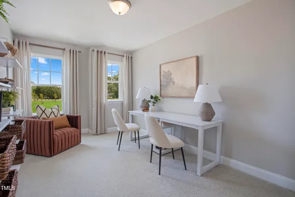 a kitchen with stainless steel appliances a table chairs refrigerator and microwave