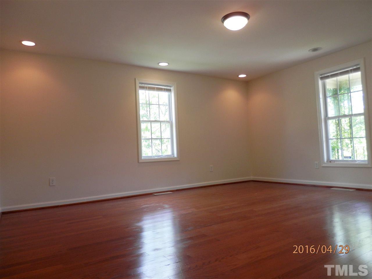 817 East Davie Street Raleigh, NC 27601 - Photo 11 of 25 an empty room with wooden floor and windows