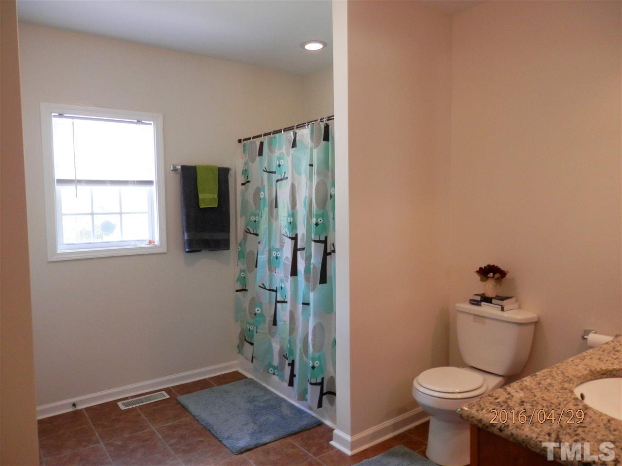 817 East Davie Street Raleigh, NC 27601 - Photo 13 of 25 a bathroom with a toilet and a shower