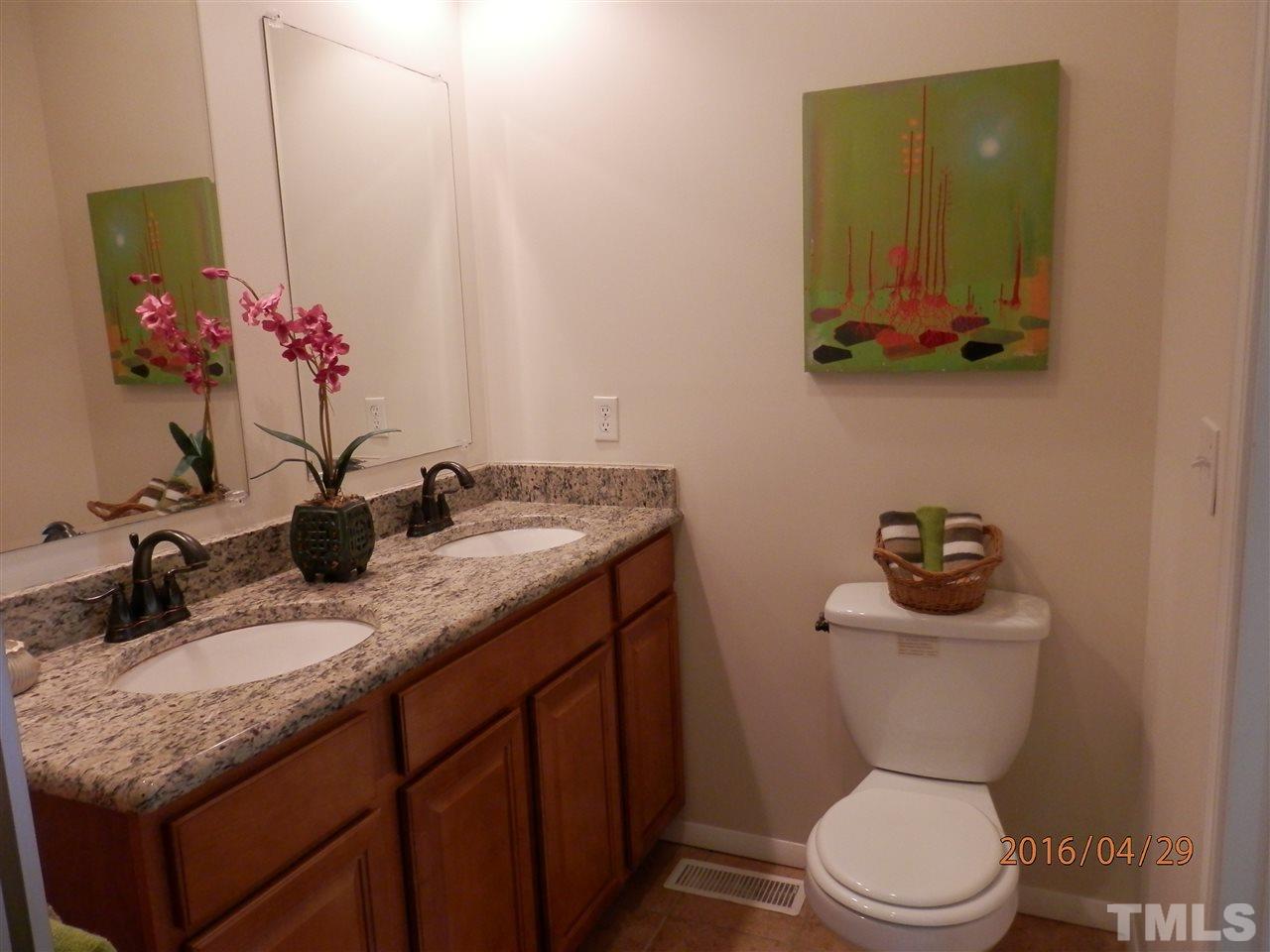 817 East Davie Street Raleigh, NC 27601 - Photo 17 of 25 a bathroom with a granite countertop toilet sink and mirror