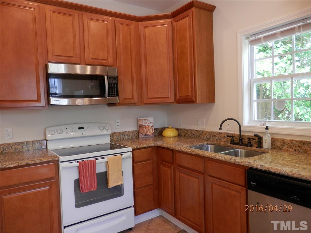 817 East Davie Street Raleigh, NC 27601 - Photo 4 of 25 a kitchen with stainless steel appliances granite countertop a sink stove and microwave
