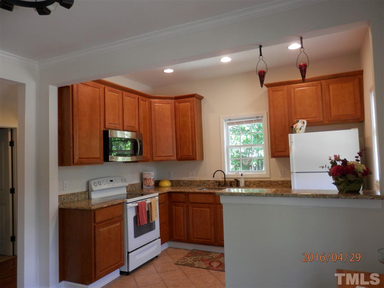 817 East Davie Street Raleigh, NC 27601 - Photo 6 of 25 a kitchen with a sink stove and microwave