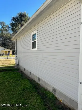a view of a backyard with sitting area