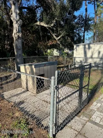 a view of a wooden deck and a backyard
