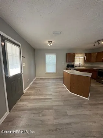 a view of a kitchen with microwave and cabinets