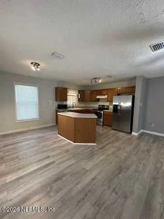 a view of kitchen with wooden floor