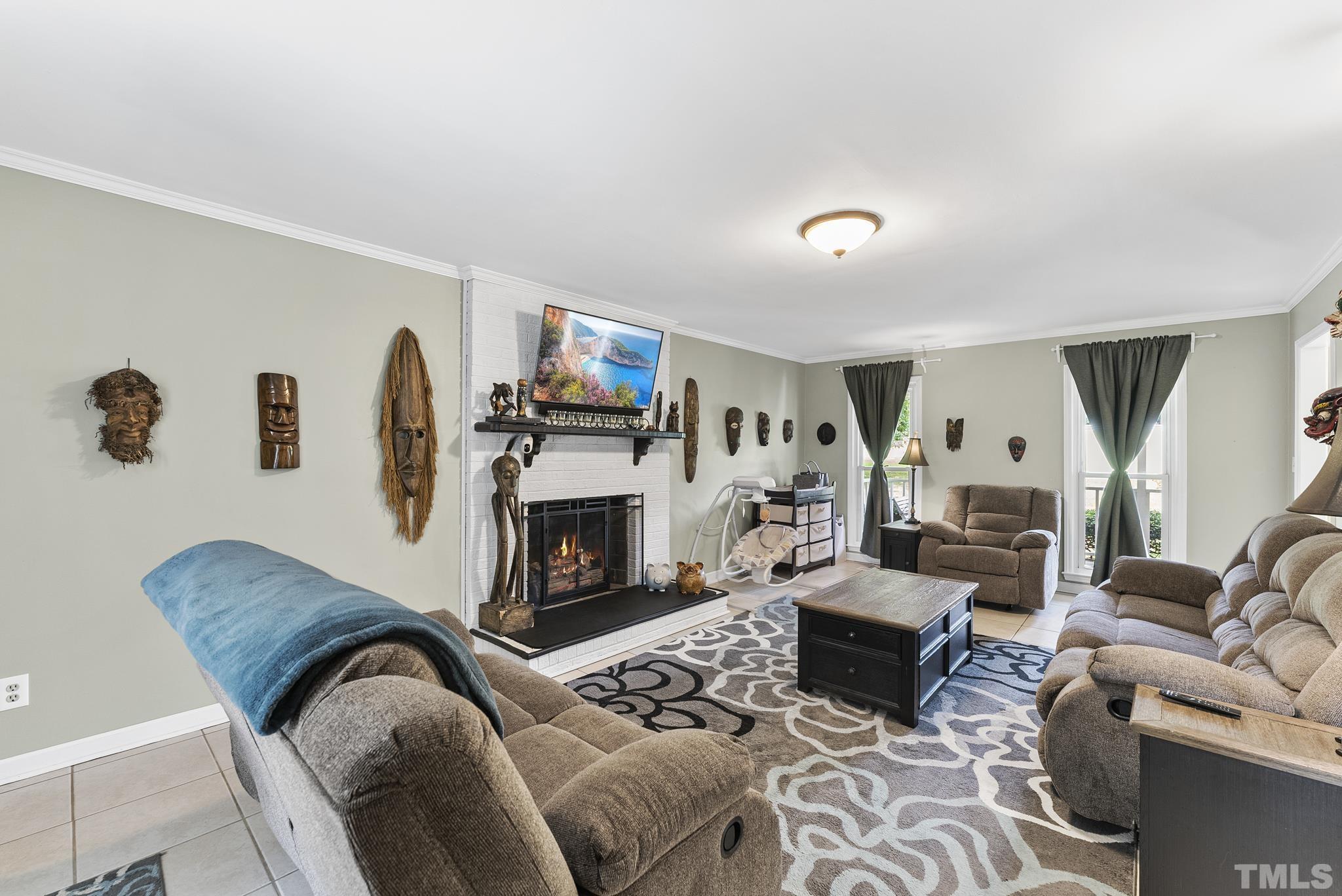 524 Jericho Road Hillsborough, NC 27278 - Photo 4 of 52 a living room with furniture flat screen tv and a fireplace