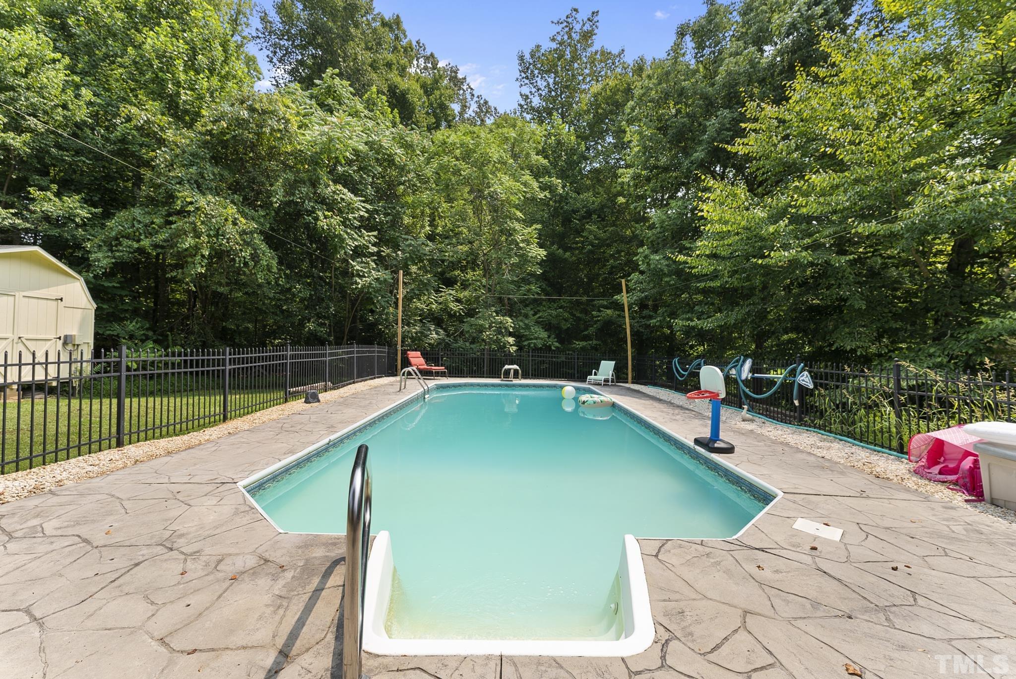 524 Jericho Road Hillsborough, NC 27278 - Photo 42 of 52 a view of a swimming pool with a patio and a yard