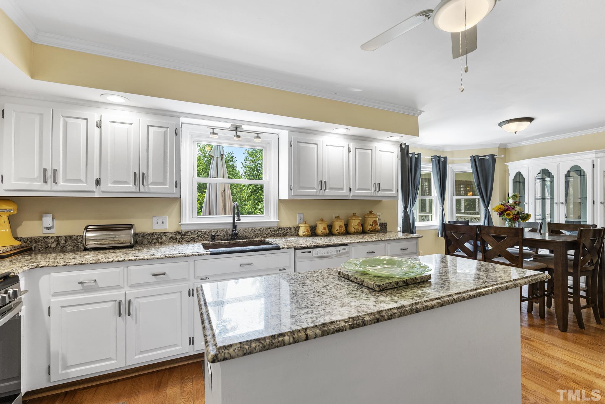 524 Jericho Road Hillsborough, NC 27278 - Photo 7 of 52 a kitchen with granite countertop a sink a stove cabinets and dining table chair
