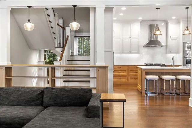 a kitchen with kitchen island a sink stove and refrigerator