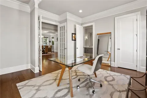 a view of a dining room with furniture a chandelier and wooden floor