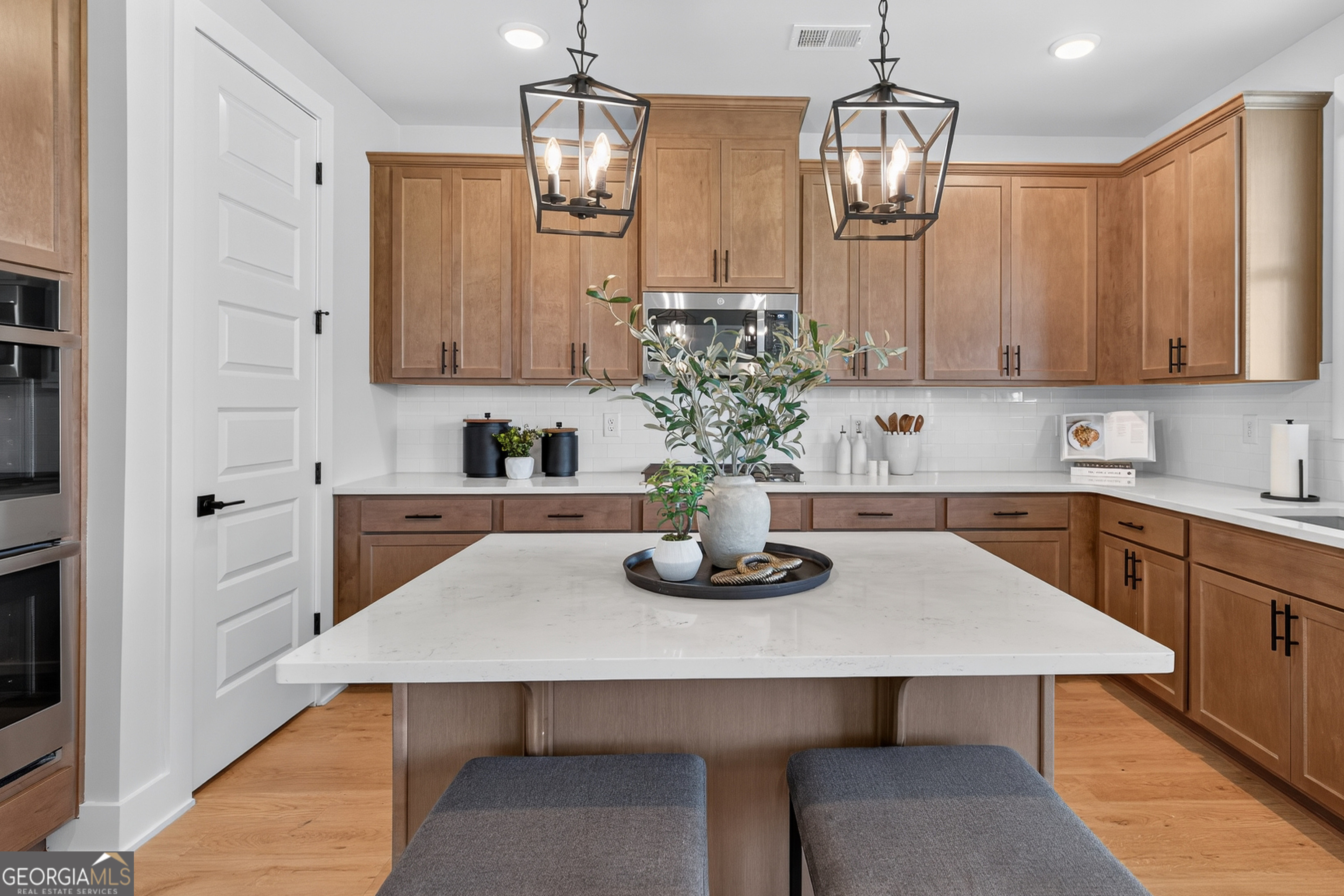 112 Patillo Manor, Unit 3 Stockbridge, GA 30281 - Photo 13 of 59 a kitchen with a table chairs and cabinets