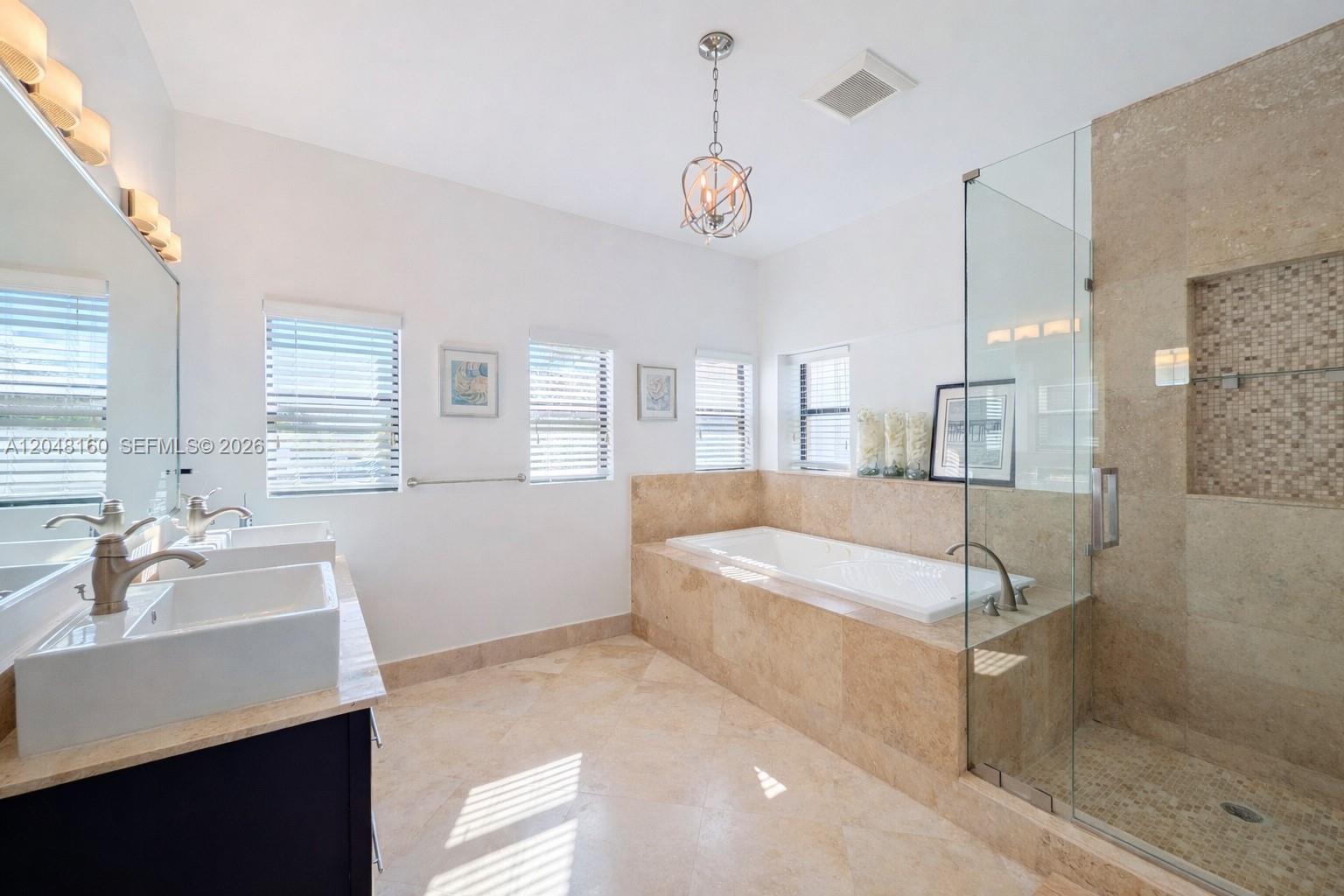 471 Southwest 30th Road Miami, FL 33129 - Photo 29 of 39 Primary suite bathroom with a whirlpool bath, glass shower, his and her sinks, a Toto bidet and separate conventional toilet.