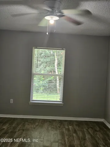 a room that has a bed and a dresser next to a window